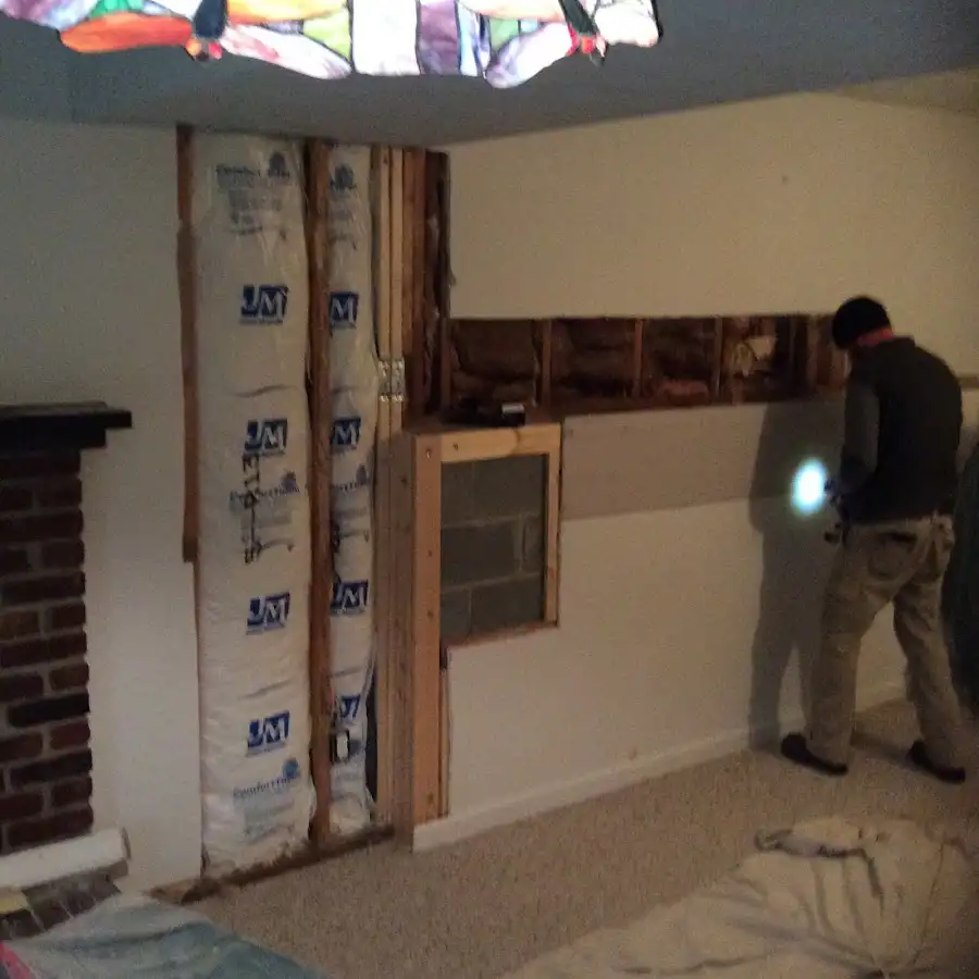 Restoration technician inspecting water damage in Doolittle